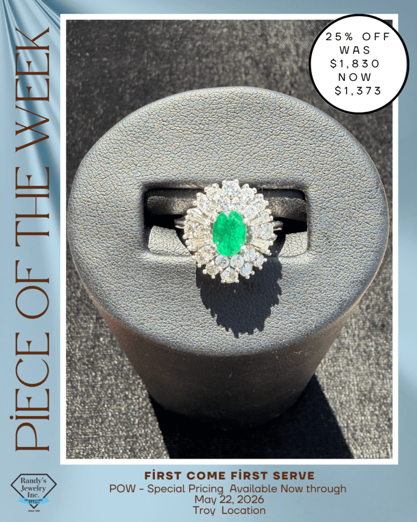 Close-up of a diamond halo ring with a vivid green emerald centerpiece on a textured display, as part of a jewelry sale poster.